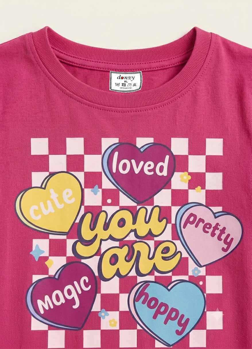 Girls' pink cotton t-shirt with colorful checkered hearts graphic print